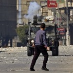 Jovem palestino e comboio militar israelense em Nablus, na Palestina - Zain Jaafar / AFP