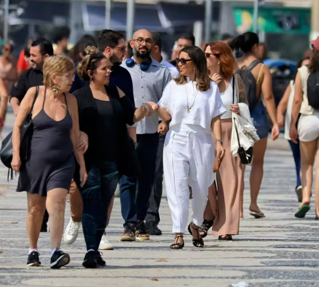 Janja caminha entre outros frequentadores pelo calçadão de Copacabana em direção ao Chopin — Foto: Dan Delmiro Divulgação